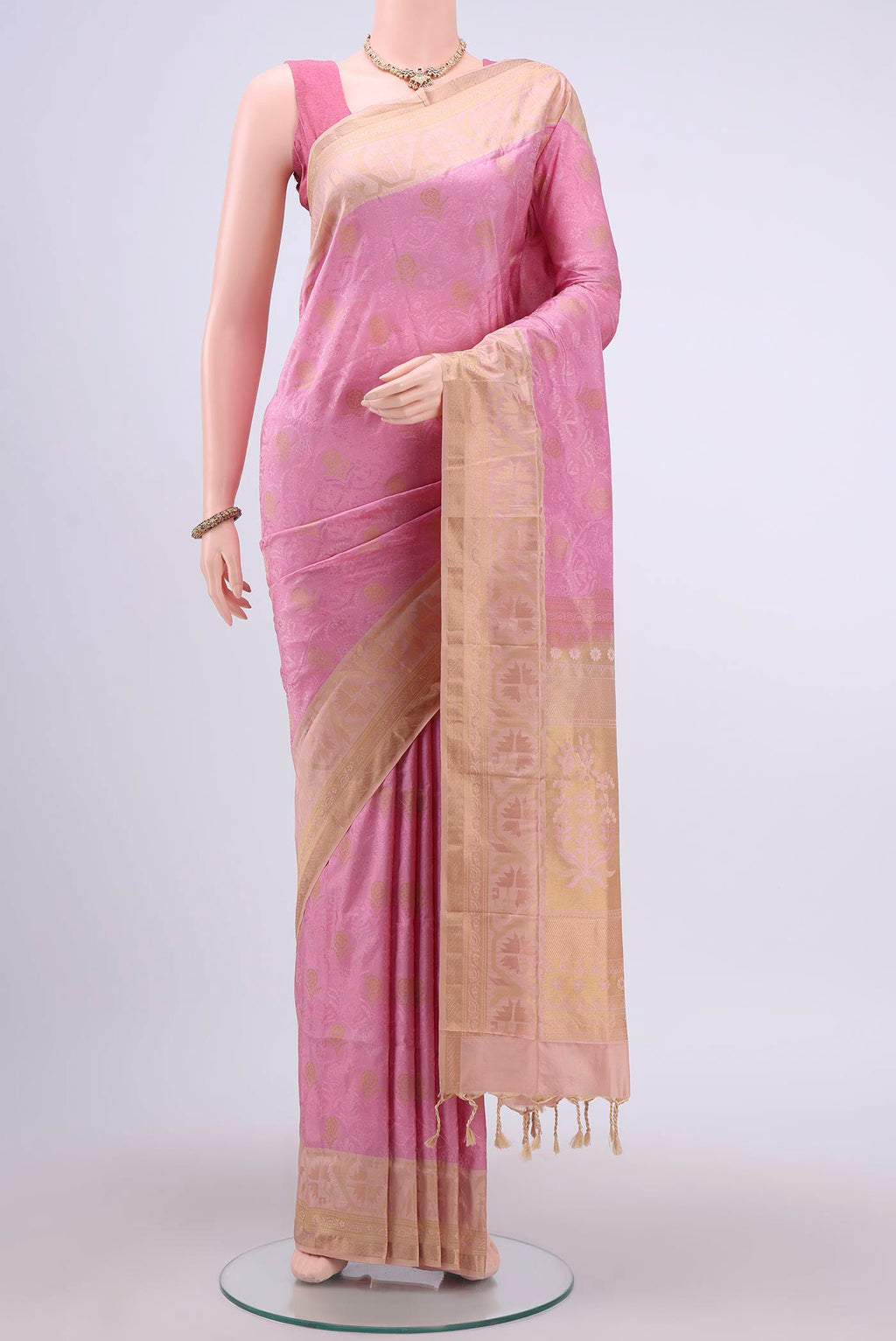 Rose Gold Soft Silk Saree with Jacquard design on the body and Zari Border displayed on a mannequin