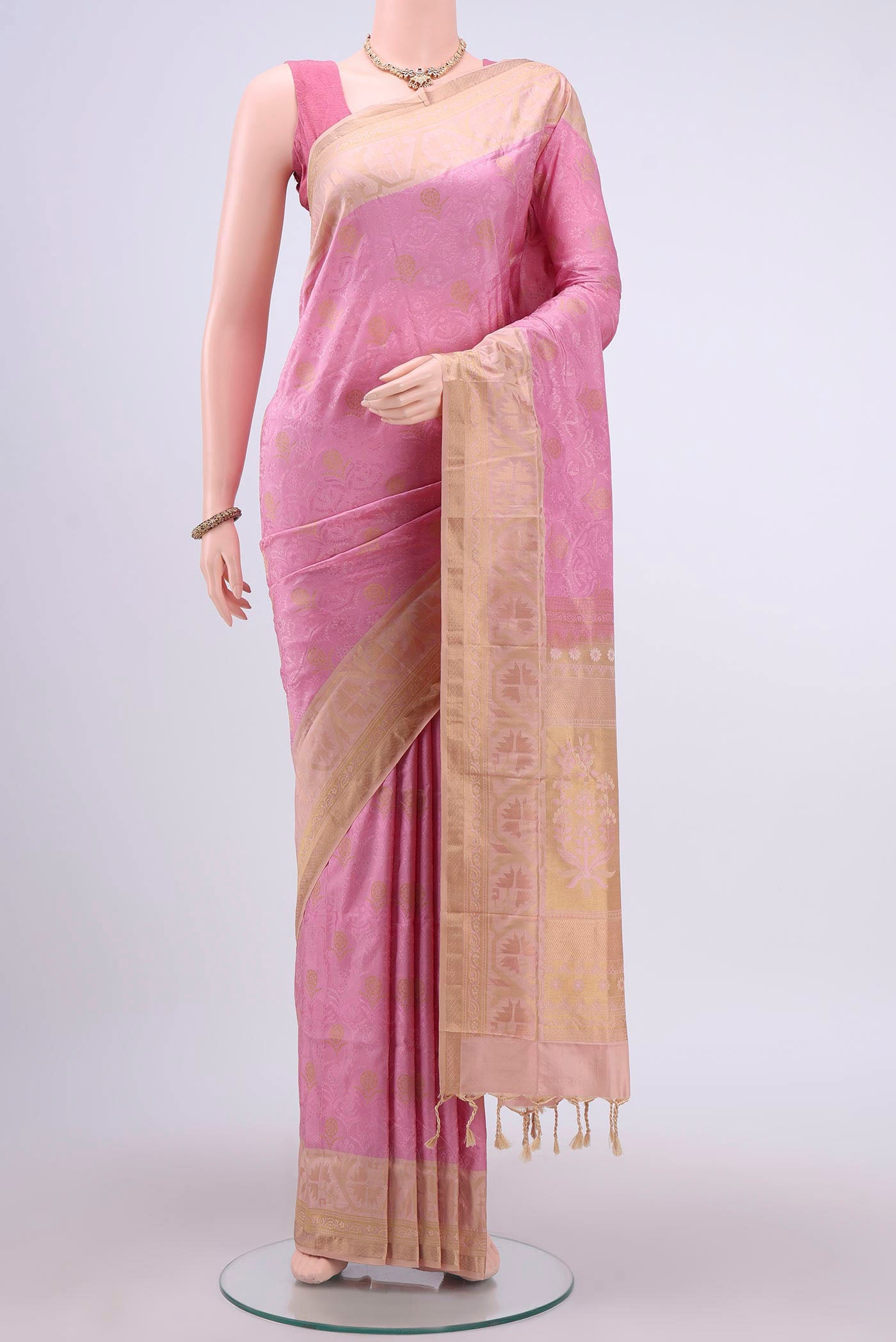 Rose Gold Soft Silk Saree with Jacquard design on the body and Zari Border displayed on a mannequin
