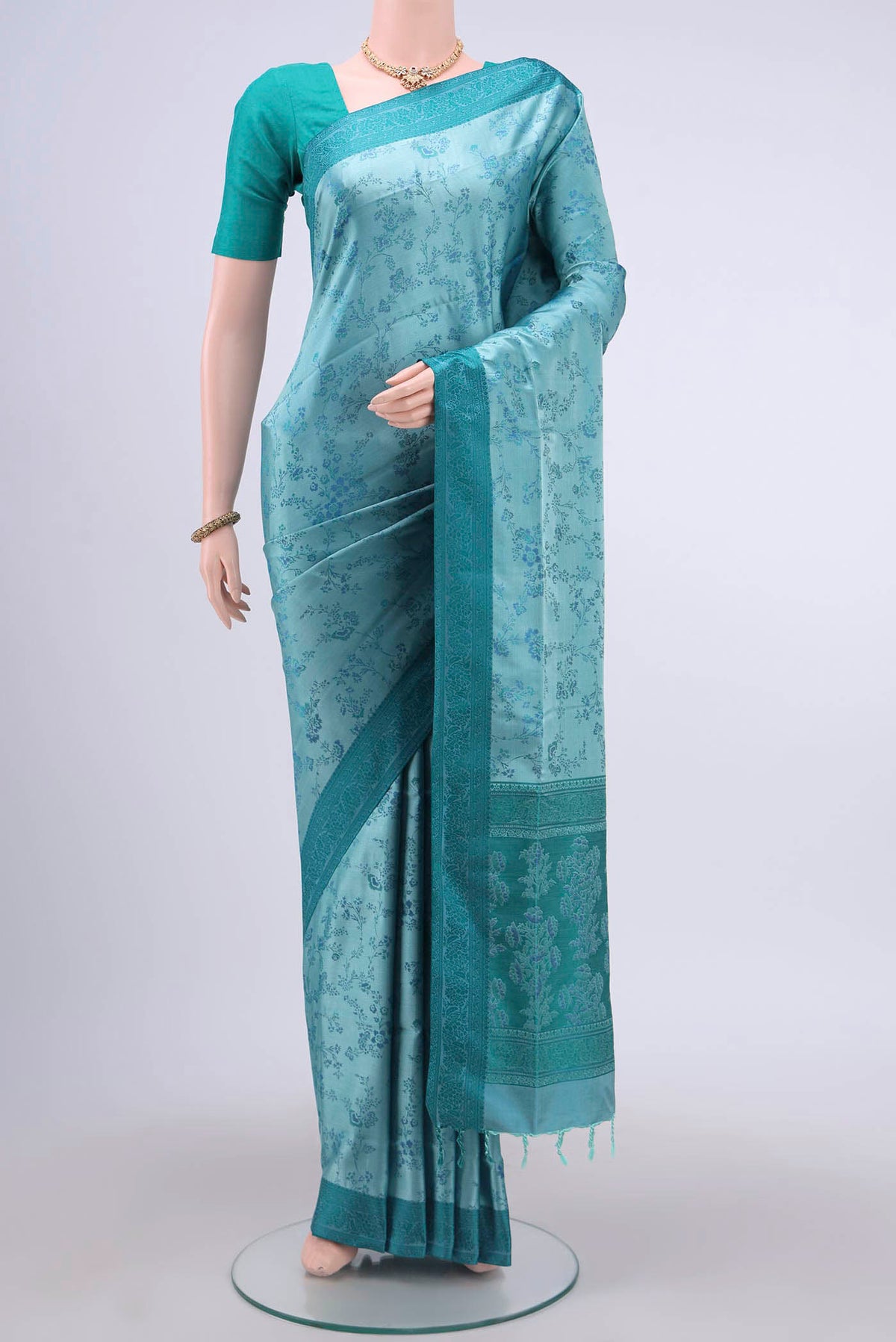 Sky Blue Soft Silk Saree with Jacquard design on the body and Thread Border displayed on a mannequin
