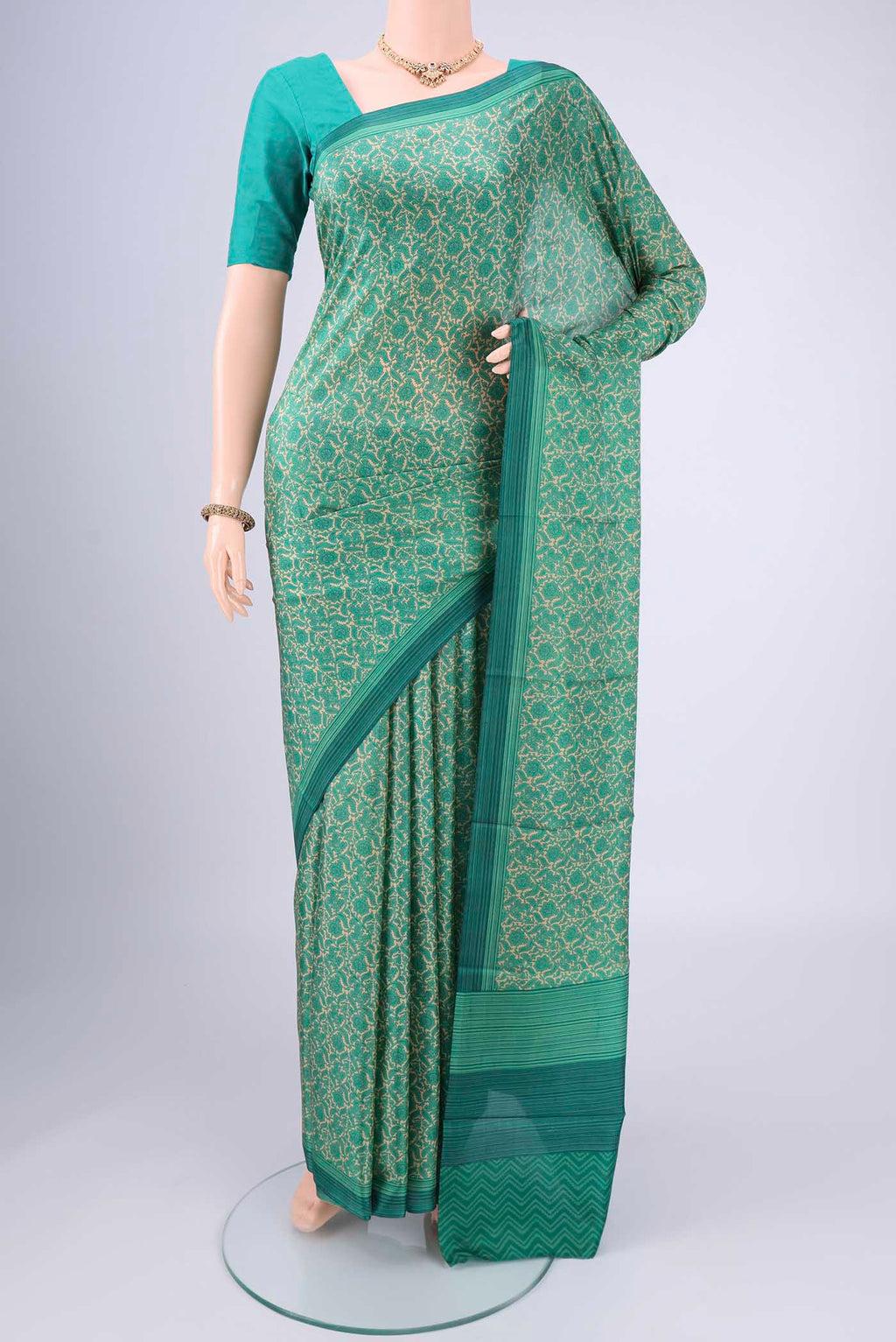 Beige Printed Silk Saree with Floral Print on the body and Printed Border.  displayed on a mannequin