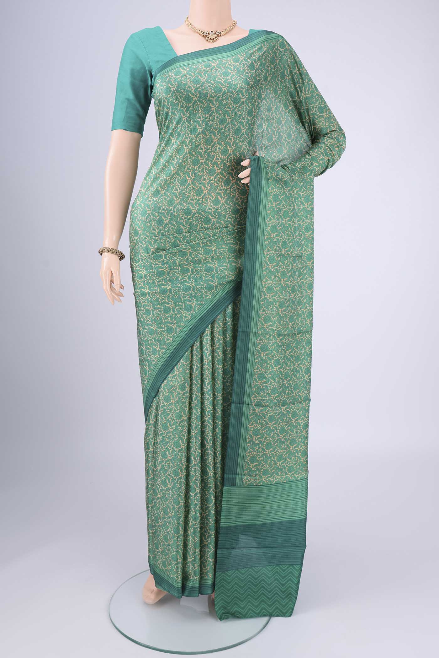 Beige Printed Silk Saree with Floral Print on the body and Printed Border.  displayed on a mannequin