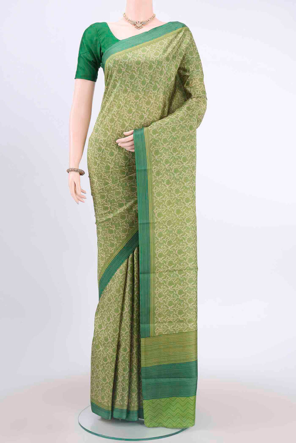 Cream Printed Silk Saree with Printed design on the body and Printed Border displayed on a mannequin