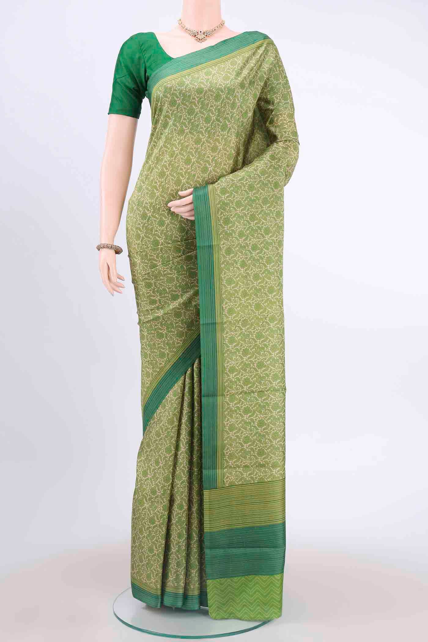 Cream Printed Silk Saree with Printed design on the body and Printed Border displayed on a mannequin