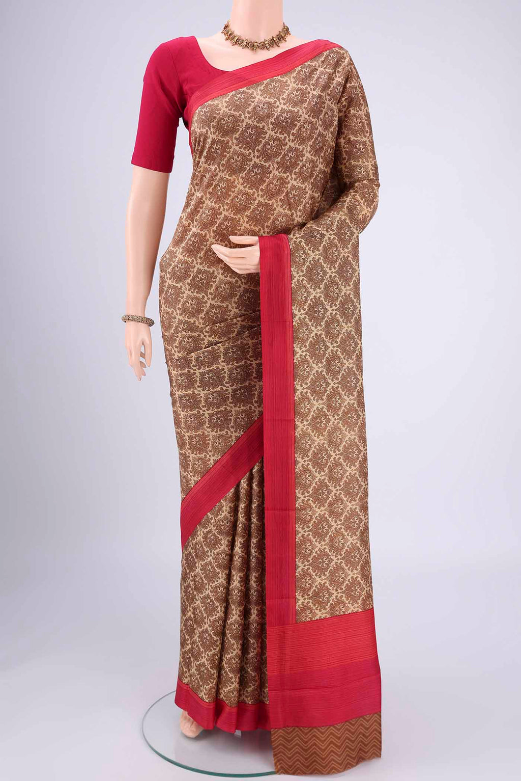 Beige Printed Silk Saree with Floral Print on the body and Printed Border.  displayed on a mannequin