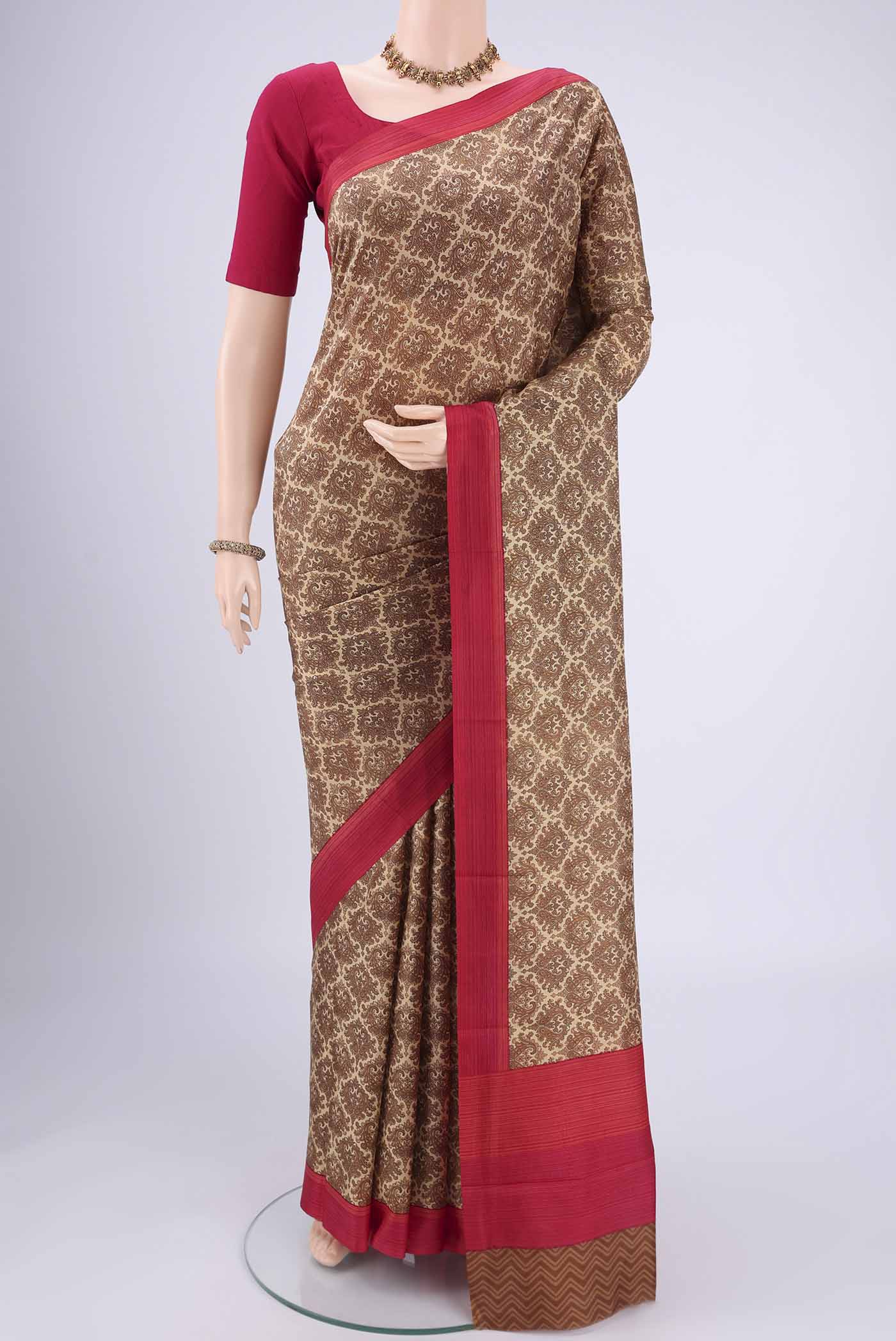 Beige Printed Silk Saree with Floral Print on the body and Printed Border.  displayed on a mannequin