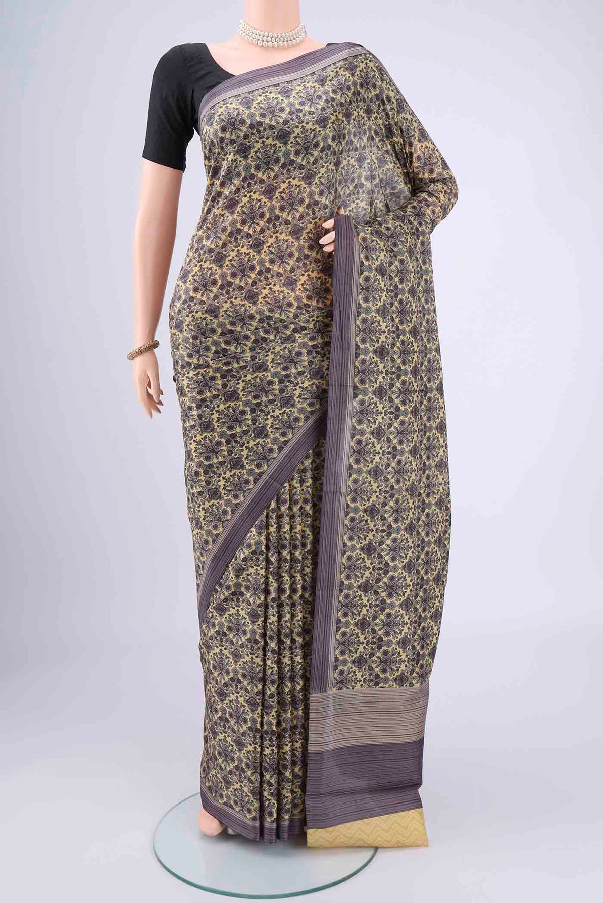 Cream Dual Tone Printed Silk Saree with Printed design on the body and Zari Border.  displayed on a mannequin