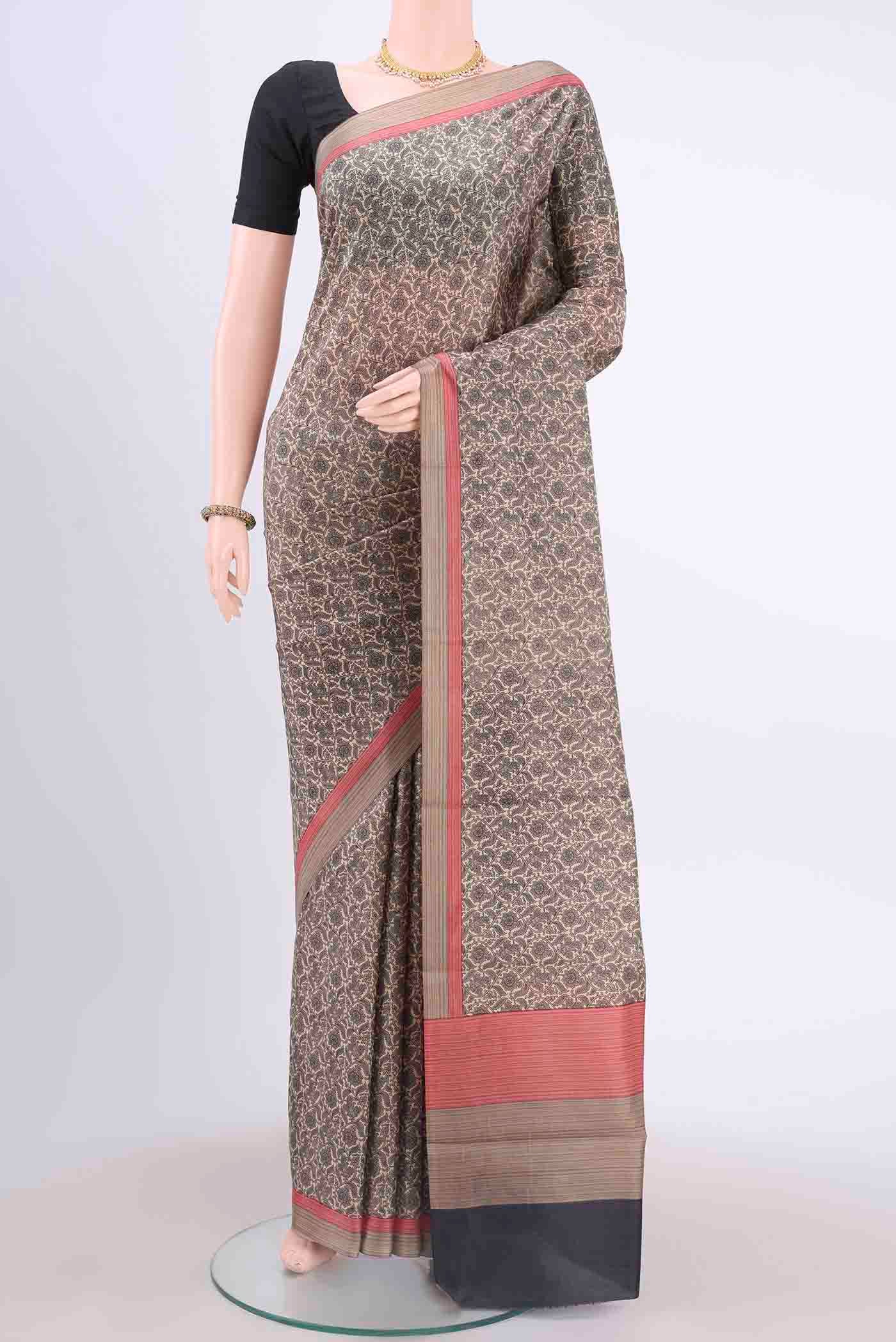 Cream Printed Silk Saree with Printed design on the body and Printed Border displayed on a mannequin