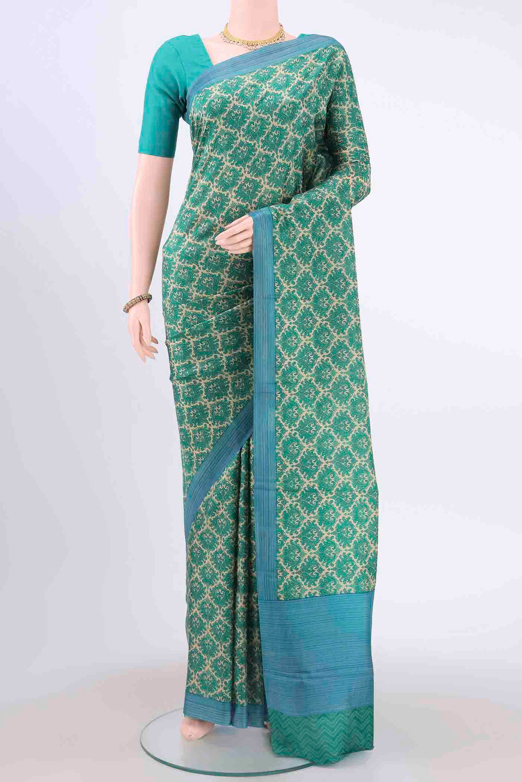 Cream Printed Silk Saree with Printed design on the body and Printed Border displayed on a mannequin