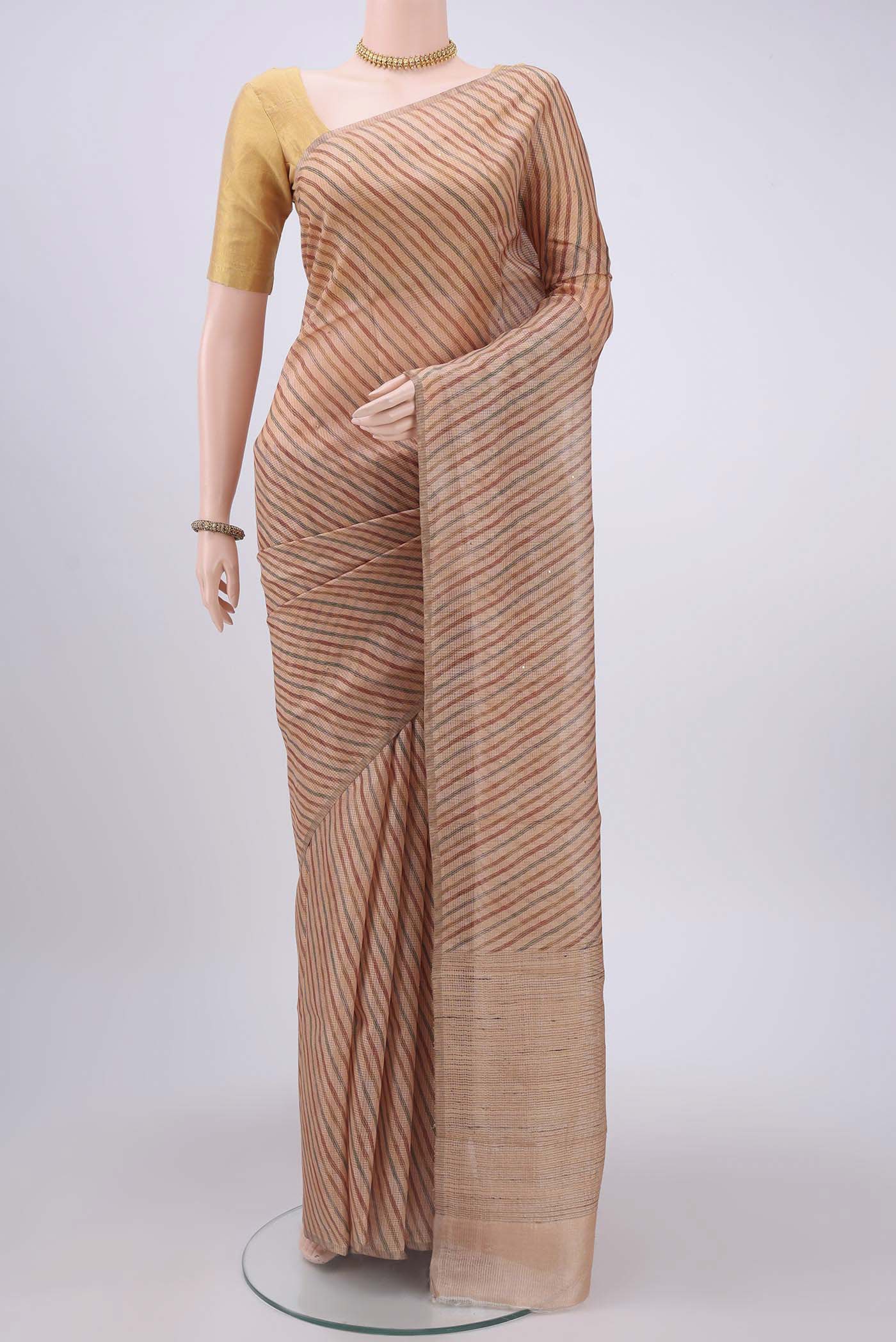 Peach Tussar Silk Saree with Printed design on the body and Printed Border displayed on a mannequin