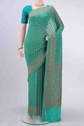 Sea Green Banarasi Georgette Saree with Zari Brocade on the body and Zari Border displayed on a mannequin