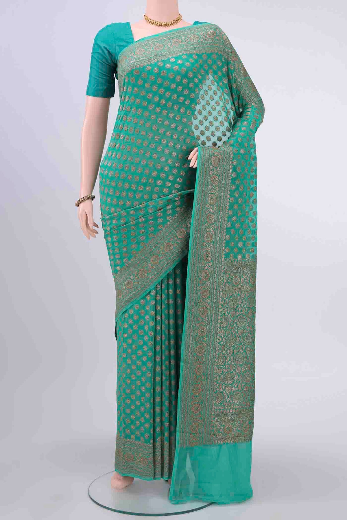 Sea Green Banarasi Georgette Saree with Zari Brocade on the body and Zari Border displayed on a mannequin