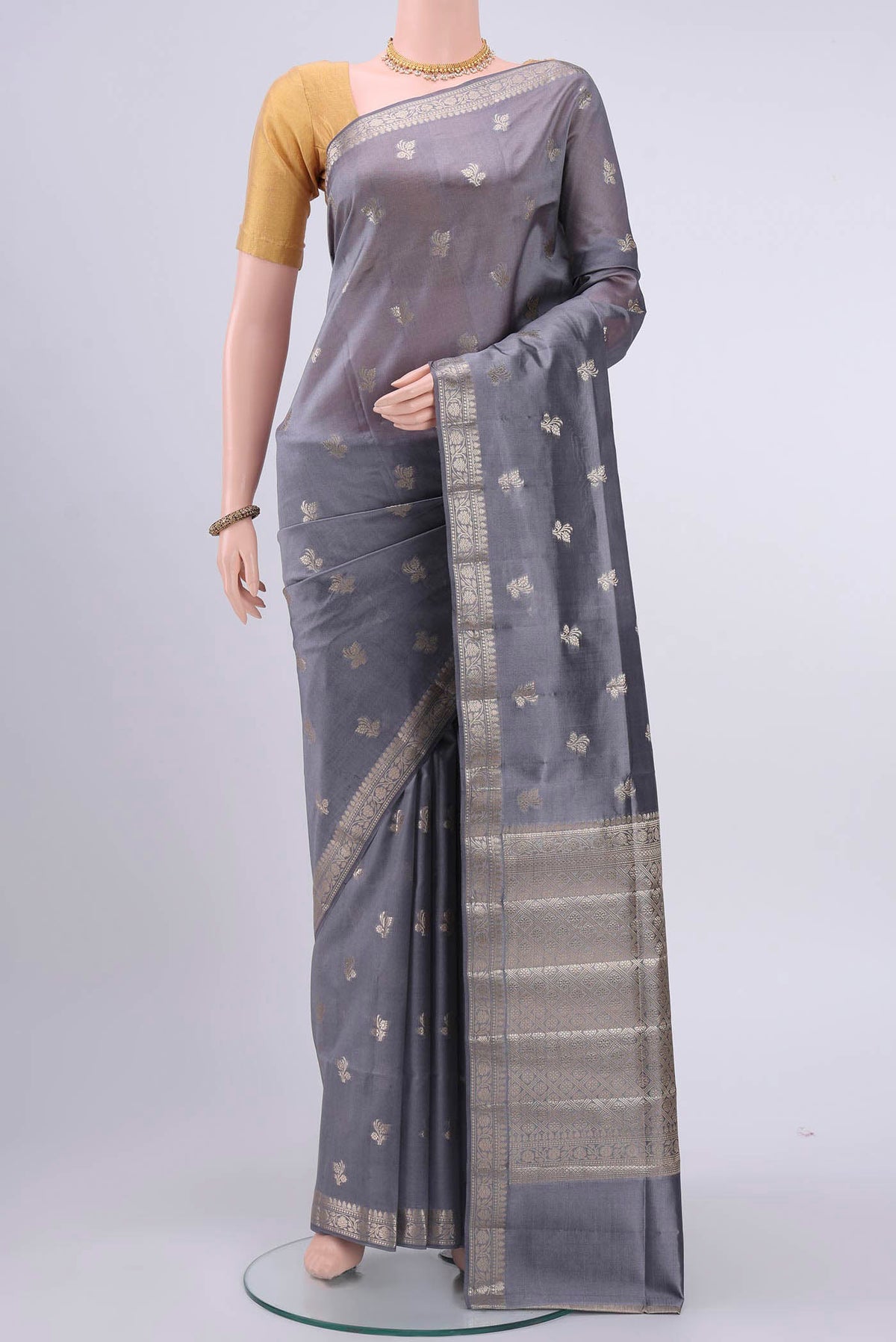Grey Banarasi Raw Silk Saree with Zari Butta on the body and Zari Border displayed on a mannequin