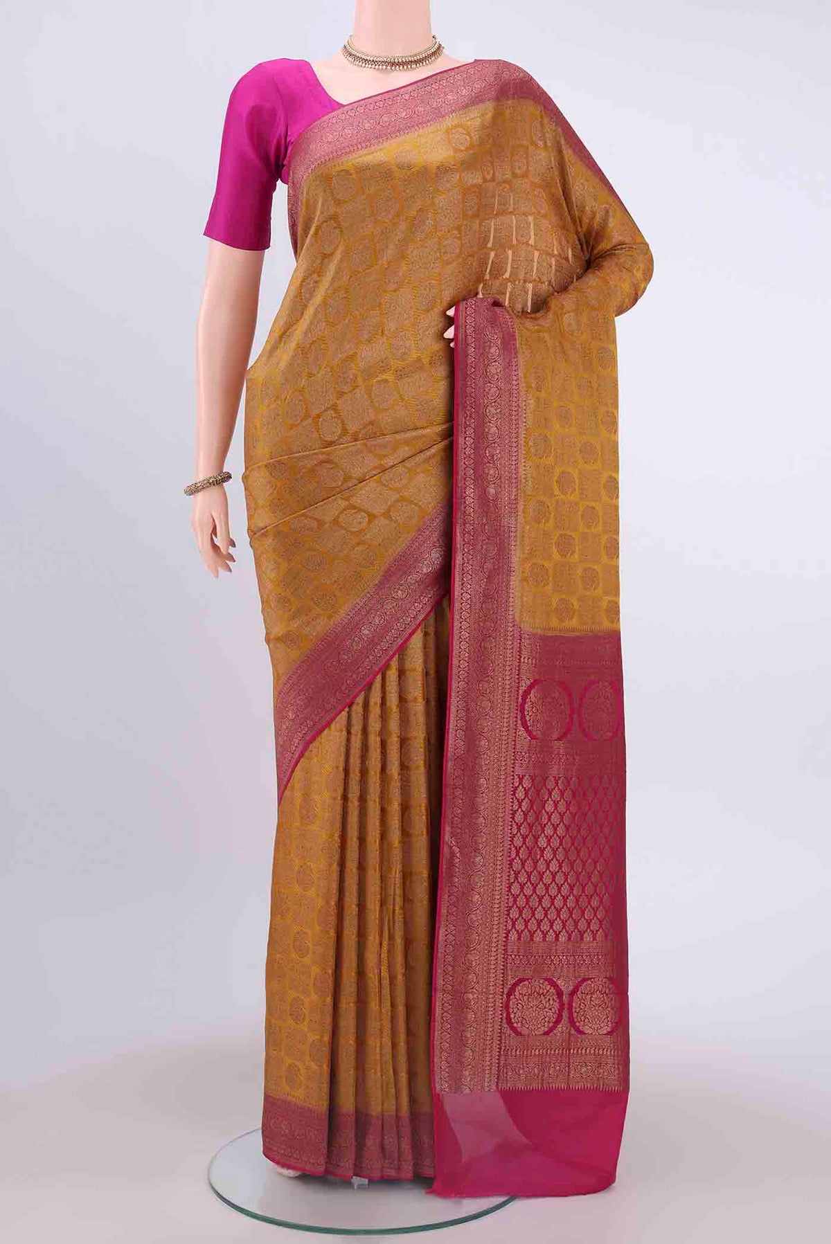 Mustard Dual Tone Mysore Crepe Saree with Zari Brocade on the body and Zari Border displayed on a mannequin