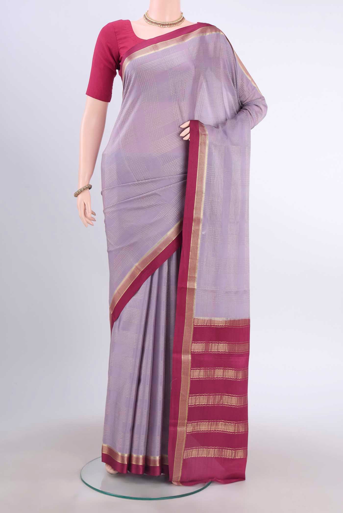 Lavender Mysore Crepe Saree with Checked design on the body and Zari Border displayed on a mannequin
