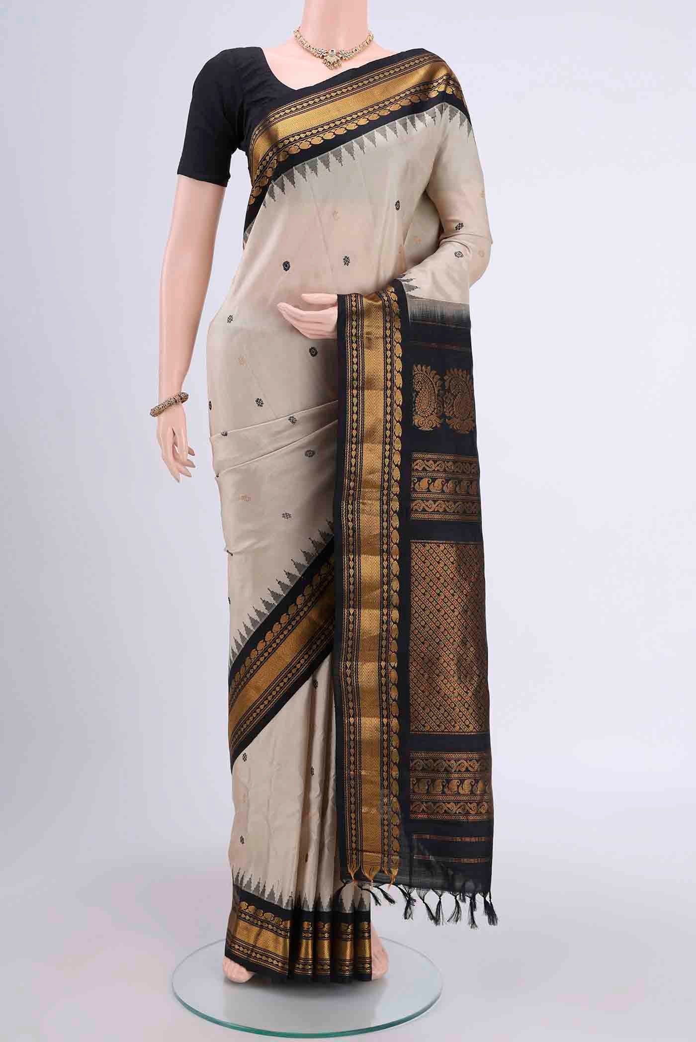 Beige Gadwal Silk Saree with Zari And Thread Butta on the body and Zari Border displayed on a mannequin