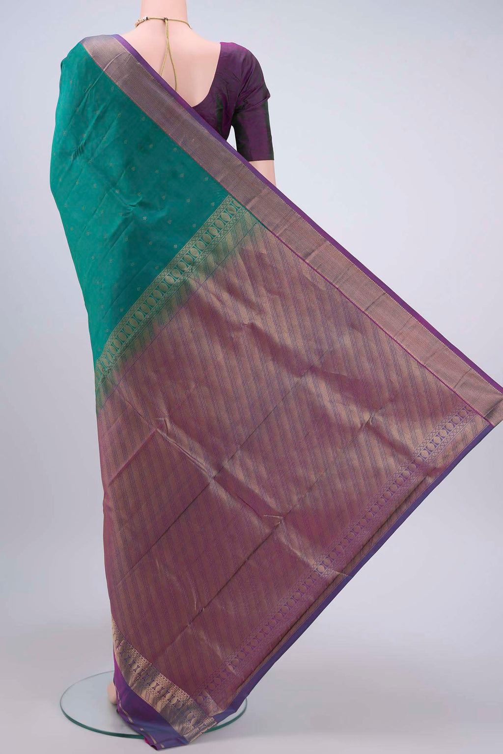 Flat view of Green Kanchipuram Silk Saree with Zari Butta on the body and Zari Border