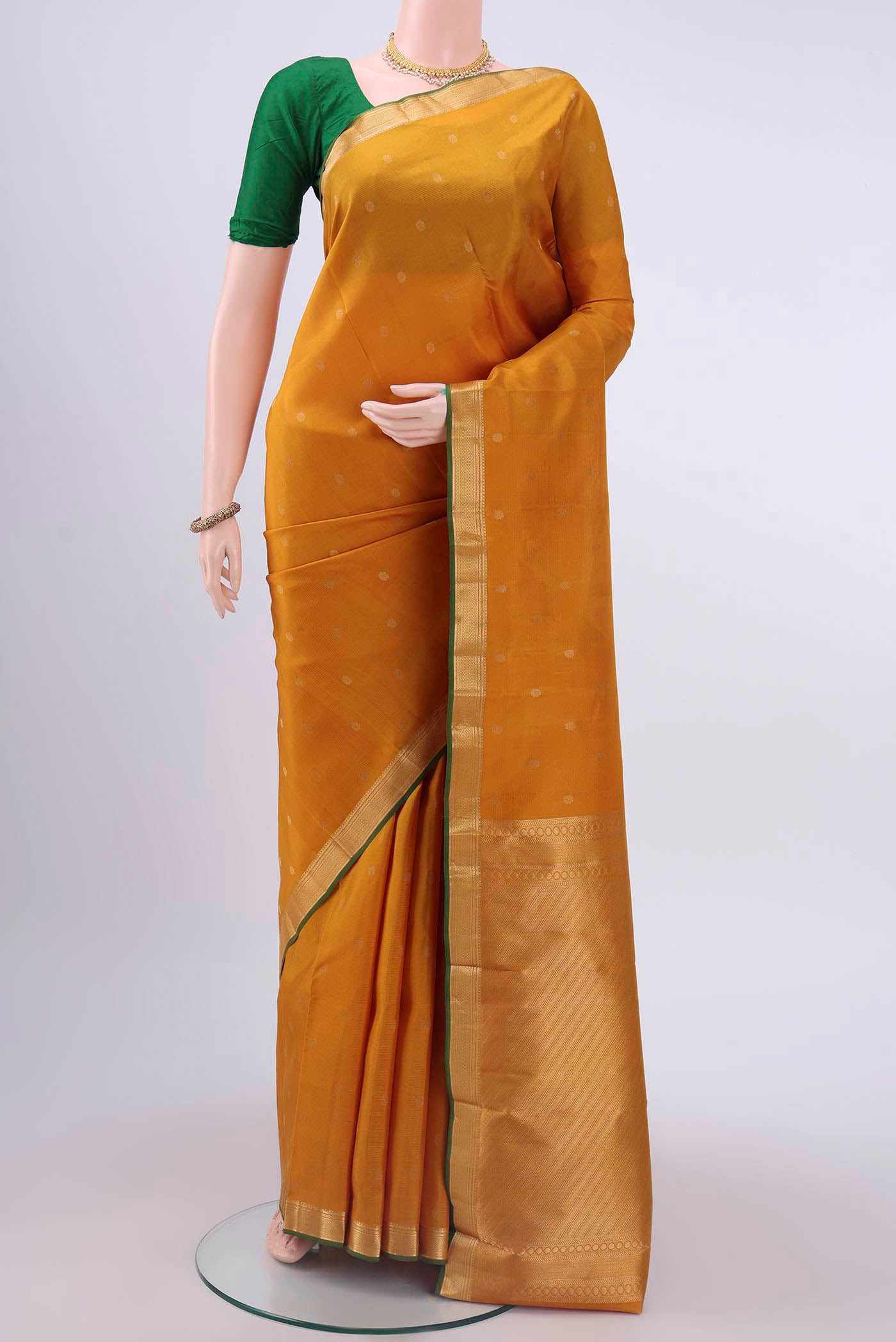 Mustard Nangavalli Silk [ Salem ] Saree with Zari Butta on the body and Zari Border displayed on a mannequin