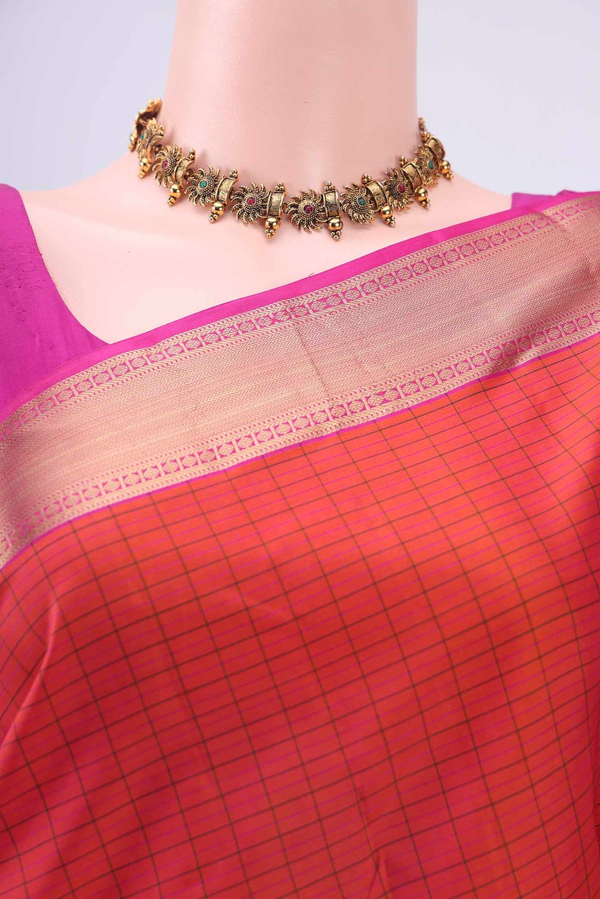 Border image of Orange Kanchipuram Silk Saree with Checked design on the body and Zari Border