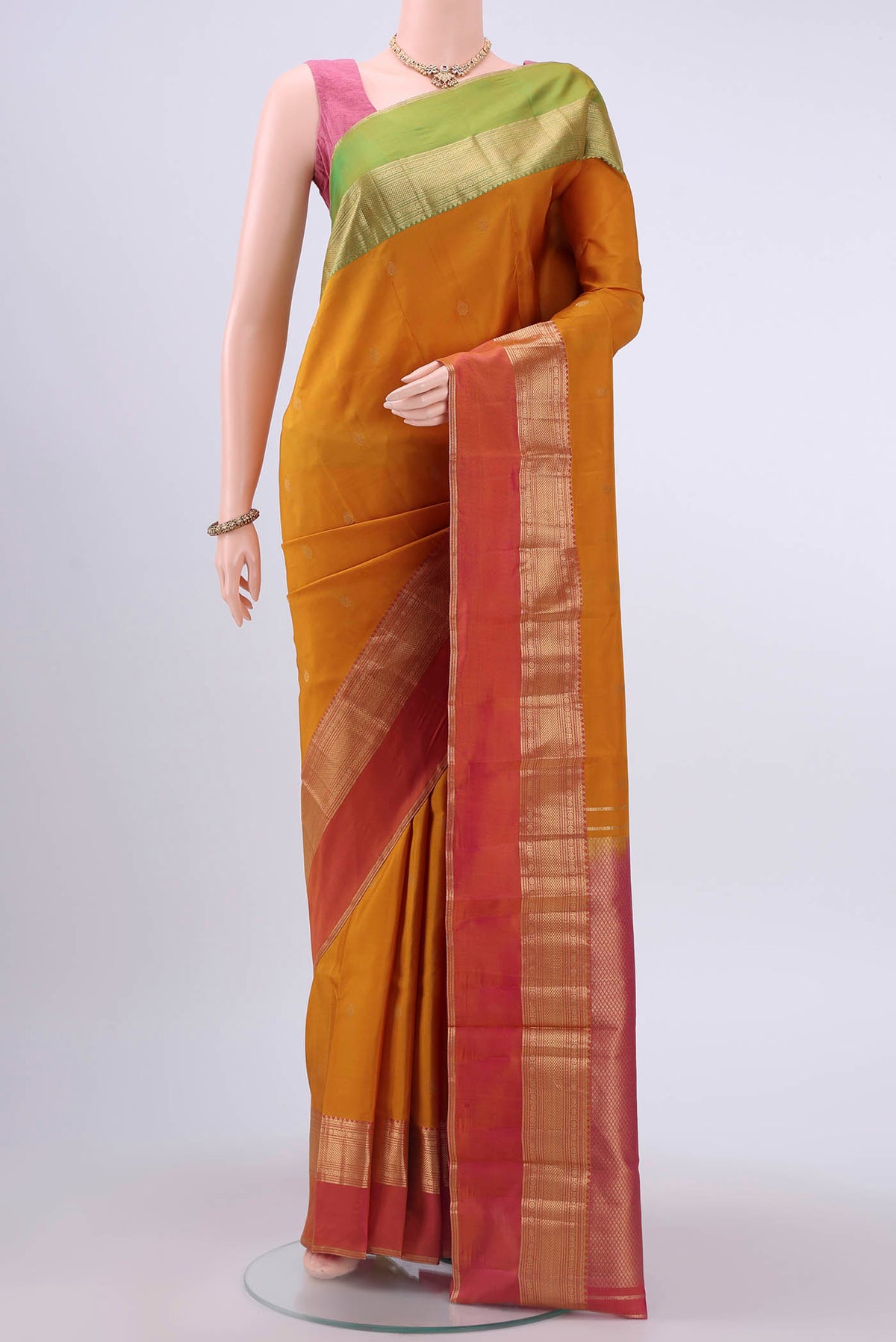 Mustard Nangavalli Silk [ Salem ] Saree with Zari Butta on the body and Ganga Jamuna Border displayed on a mannequin