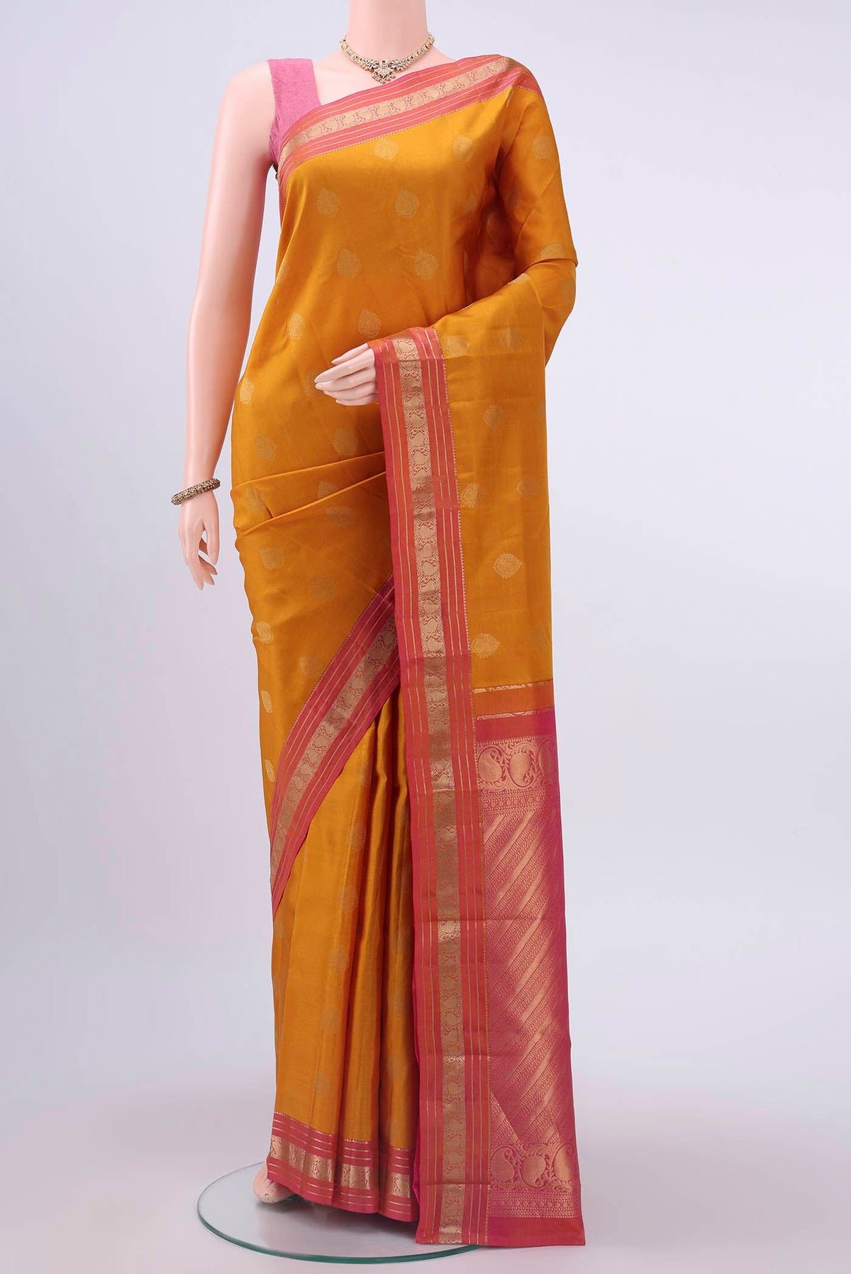 Mustard Nangavalli Silk [ Salem ] Saree with Zari Butta on the body and Zari Border displayed on a mannequin