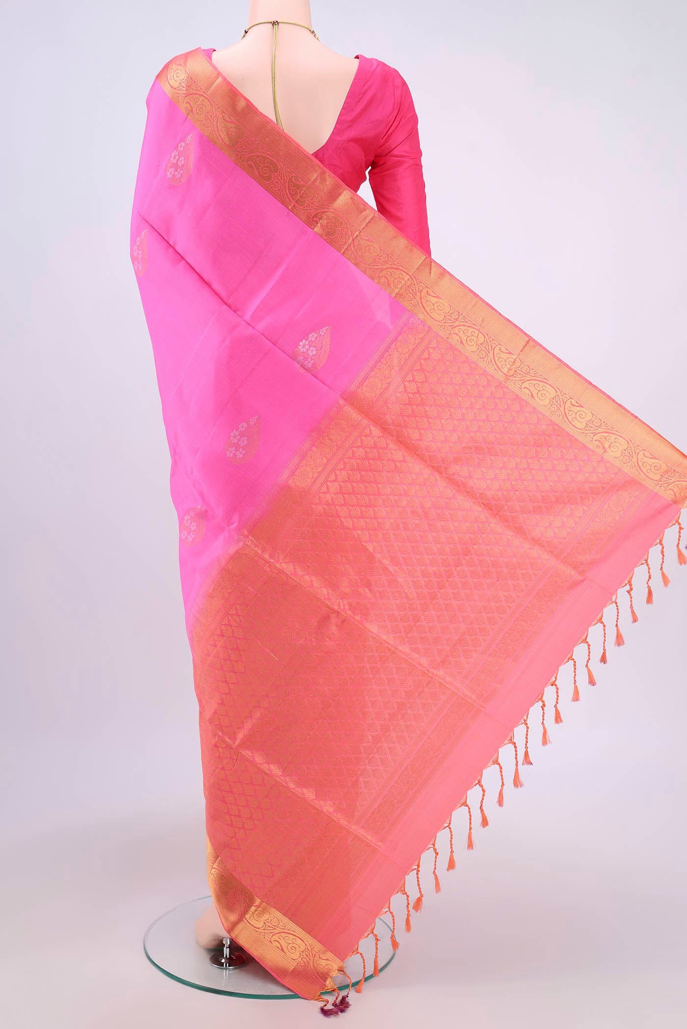 Flat view of Pink Soft Silk Saree with Zari Butta on the body and Zari Border. 
