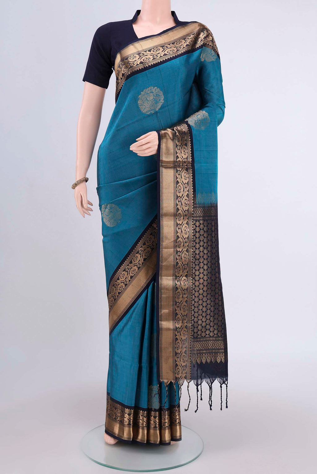 Blue Soft Silk Saree with Zari Butta on the body and Zari Border.  displayed on a mannequin