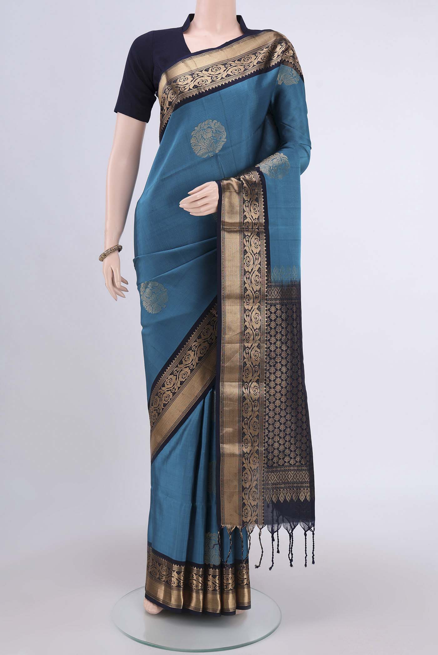 Blue Soft Silk Saree with Zari Butta on the body and Zari Border.  displayed on a mannequin
