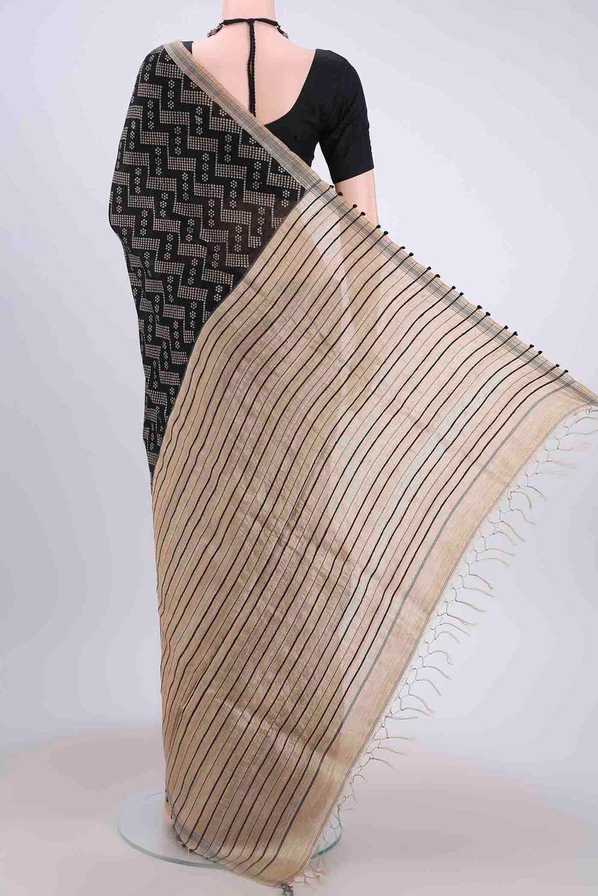 Flat view of Black Tussar Silk Saree with Zig Zag design on the body and Plain Border