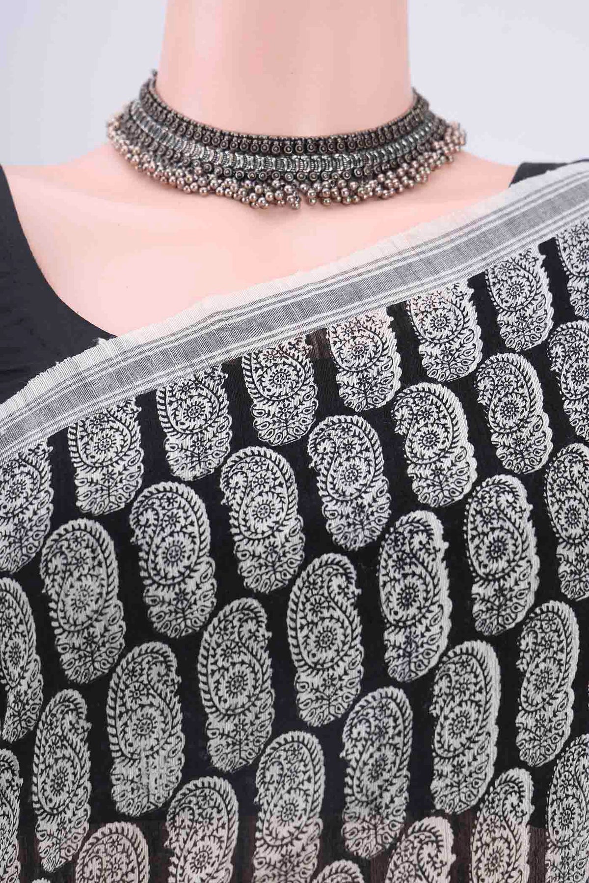Border image of Black Tussar Silk Saree with Floral Print on the body and Thread Border