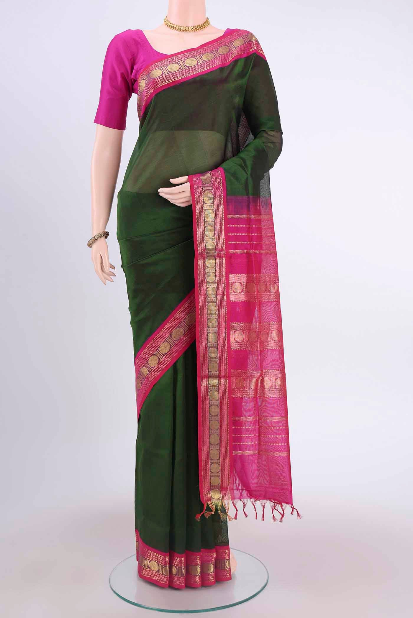 Bottle Green Blended Coimbatore Silk Cotton Saree with Plain Body and Zari Border displayed on a mannequin