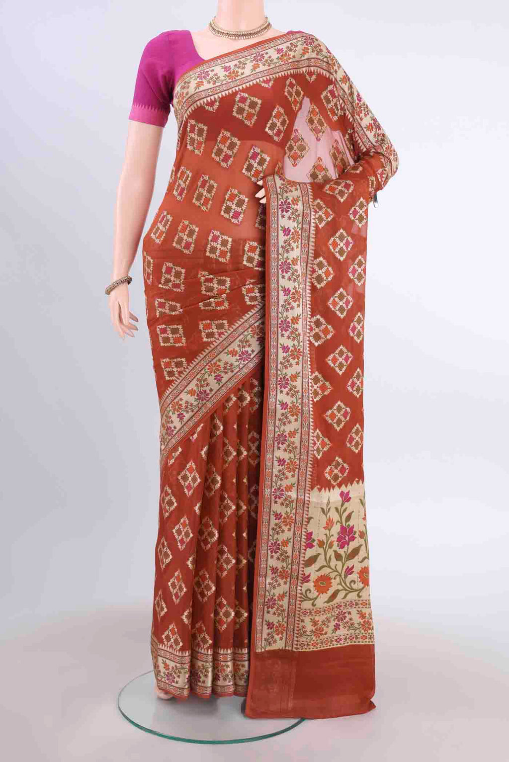 Brown Banarasi Georgette Saree with Thread Butta on the body and Thread Border displayed on a mannequin