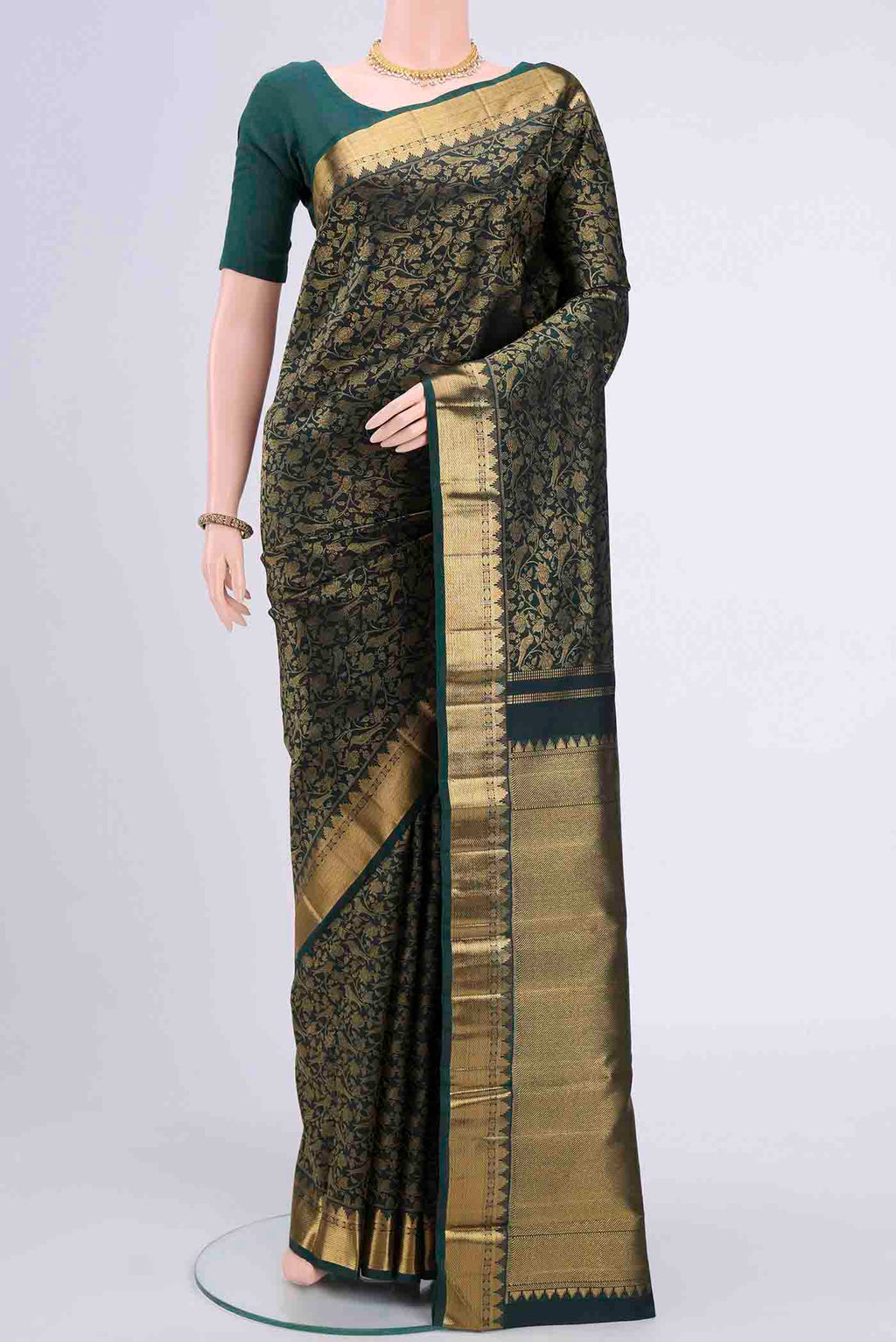 Bottle Green Kanchipuram Saree with Zari Brocade on the body and Zari Border displayed on a mannequin