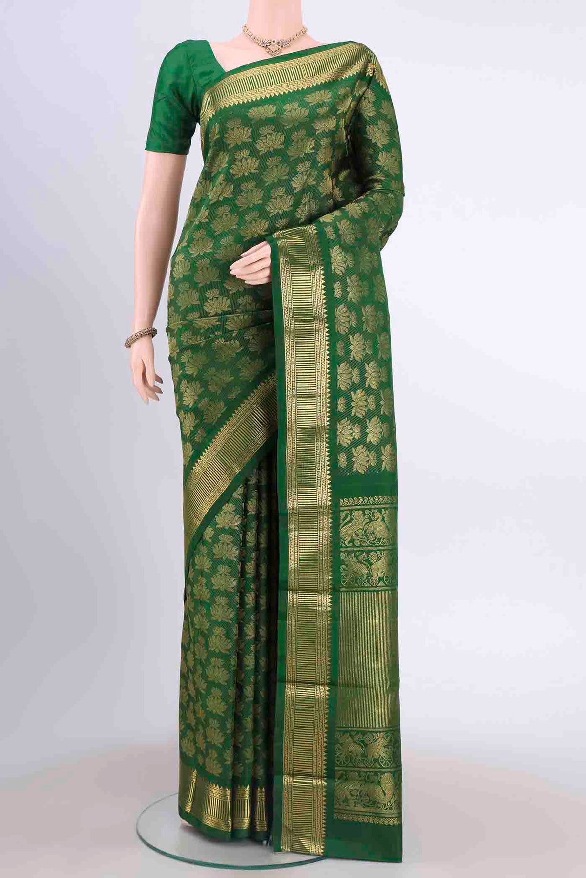 Green Dual Tone Kanchipuram Saree with Zari Brocade on the body and Zari Border displayed on a mannequin