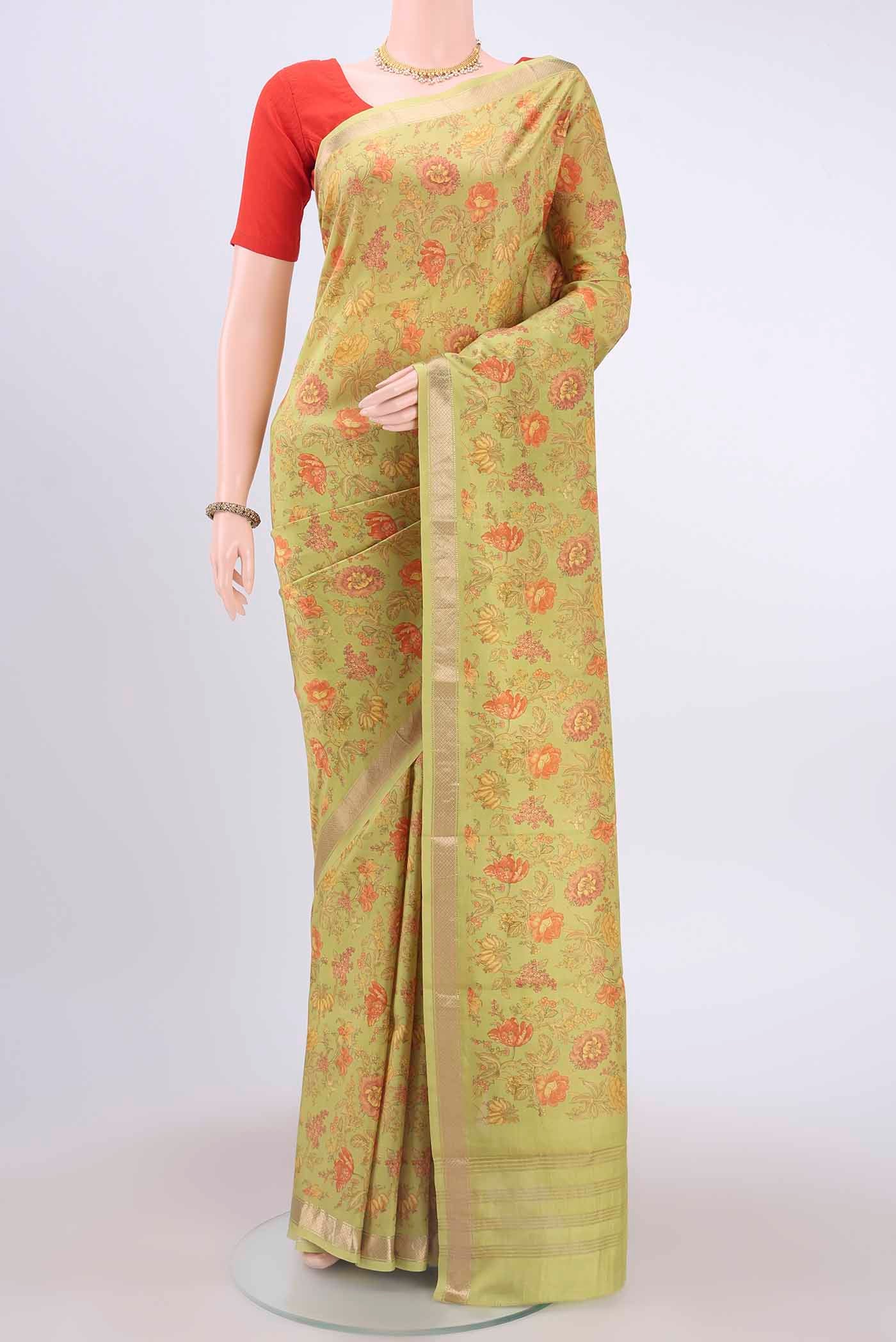 Parrot Green Printed Silk Saree with Floral Print on the body and Zari Border displayed on a mannequin
