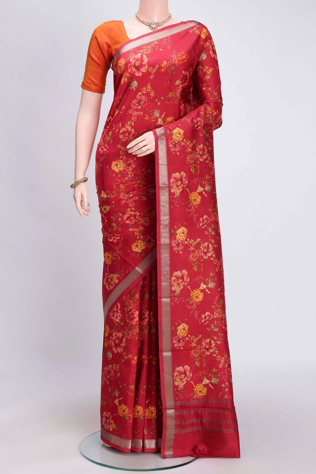 Imperial Red Printed Silk Saree with Floral Print on the body and Zari Border.  displayed on a mannequin