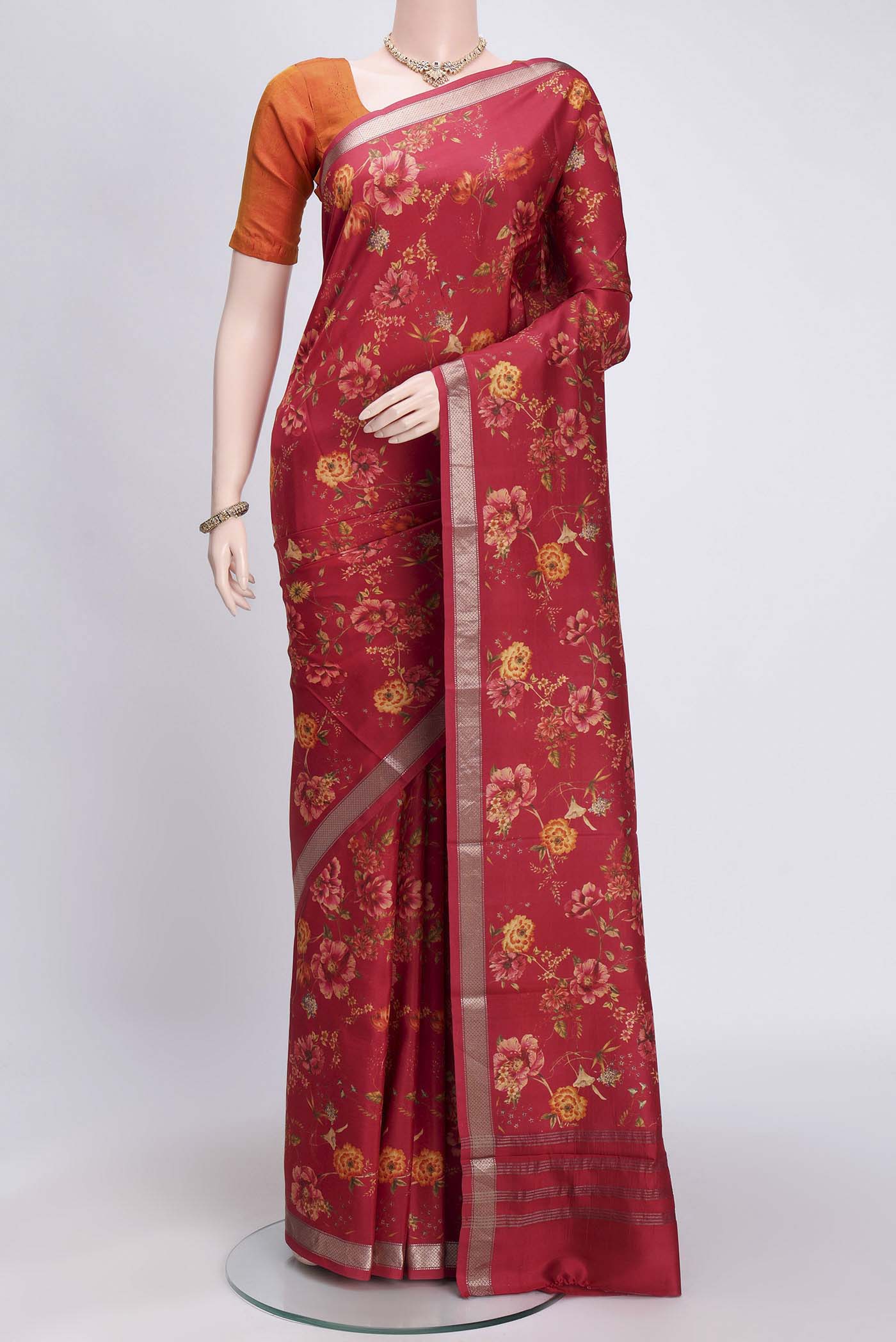 Imperial Red Printed Silk Saree with Floral Print on the body and Zari Border.  displayed on a mannequin