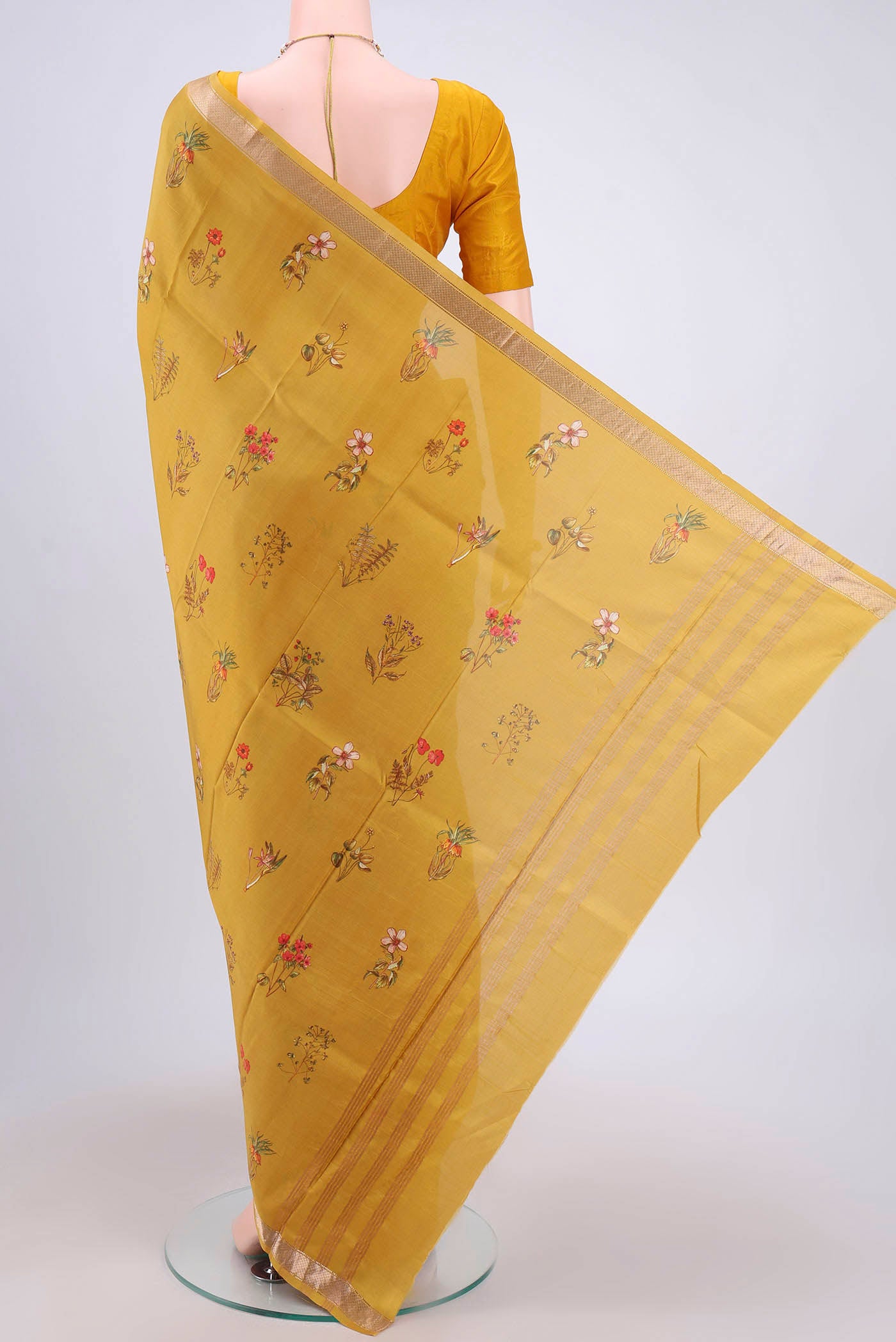 Flat view of Mustard Mysore Crepe Saree with Floral Print on the body and Zari Border. 