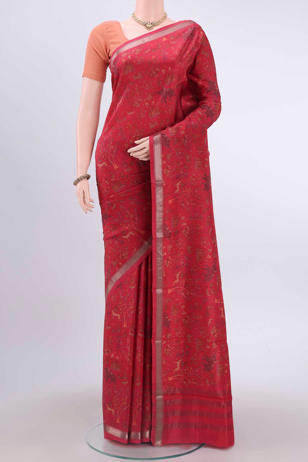 Maroon Printed Silk Saree with Floral Print on the body and Zari Border displayed on a mannequin