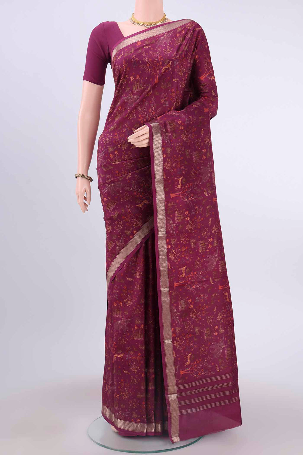 Magenta Printed Silk Saree with Floral Print on the body and Zari Border displayed on a mannequin