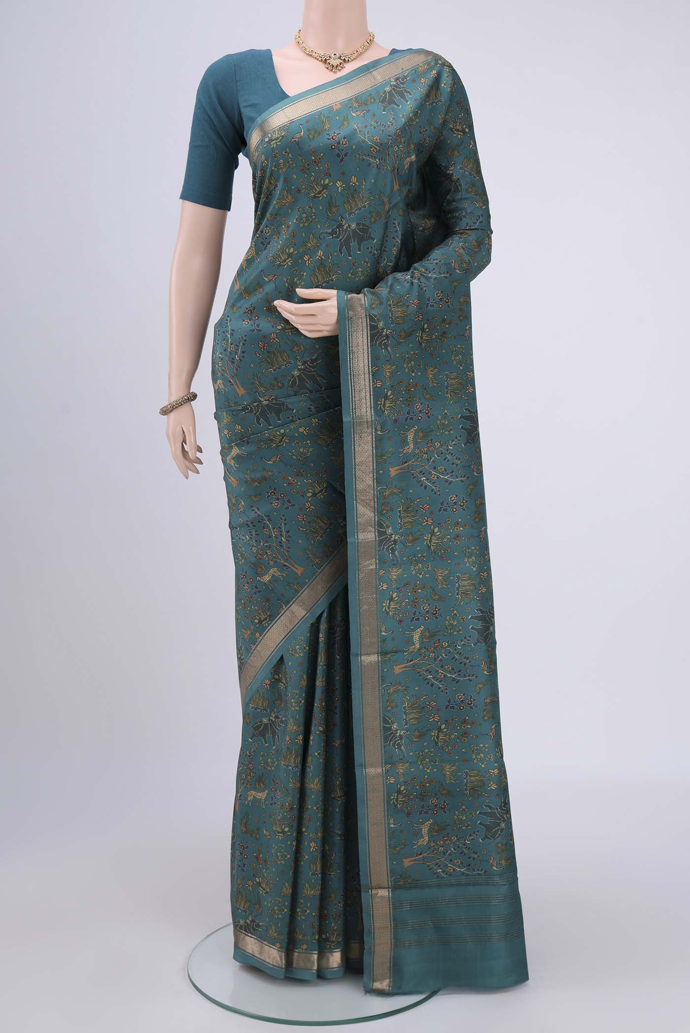 Sea Green Printed Silk Saree with Printed design on the body and Zari Border.  displayed on a mannequin