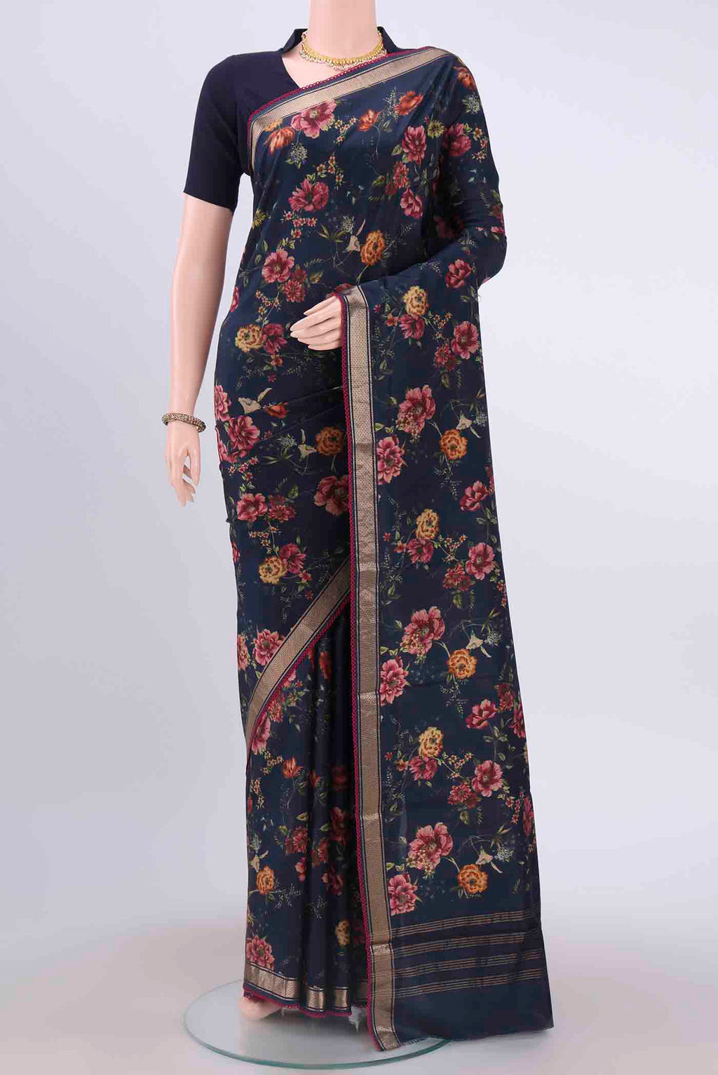 Navy Blue Printed Silk Saree with Floral Print on the body and Zari Border displayed on a mannequin