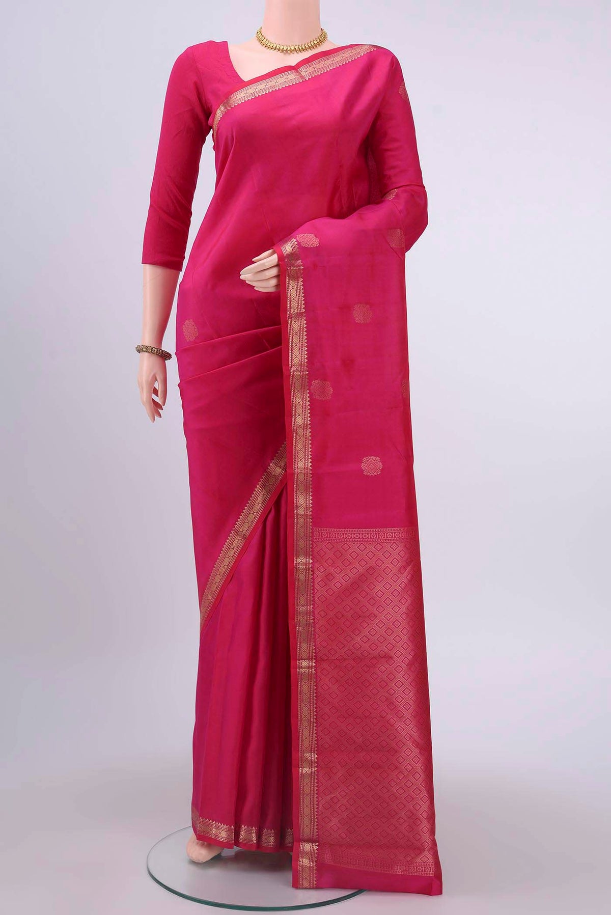 Rani Pink Nangavalli Silk [ Salem ] Saree with Zari Butta on the body and Zari Border displayed on a mannequin