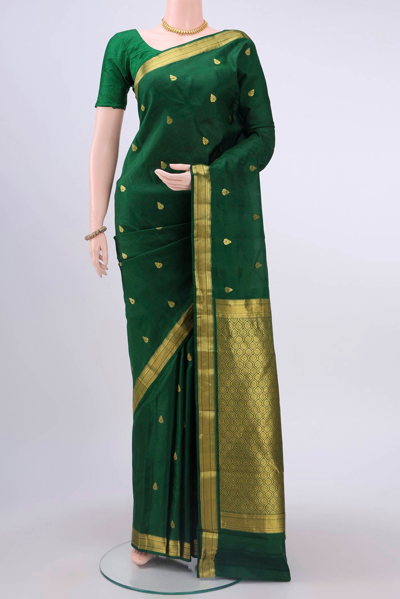Bottle Green Nangavalli Silk [ Salem ] Saree with Zari Butta on the body and Zari Border displayed on a mannequin