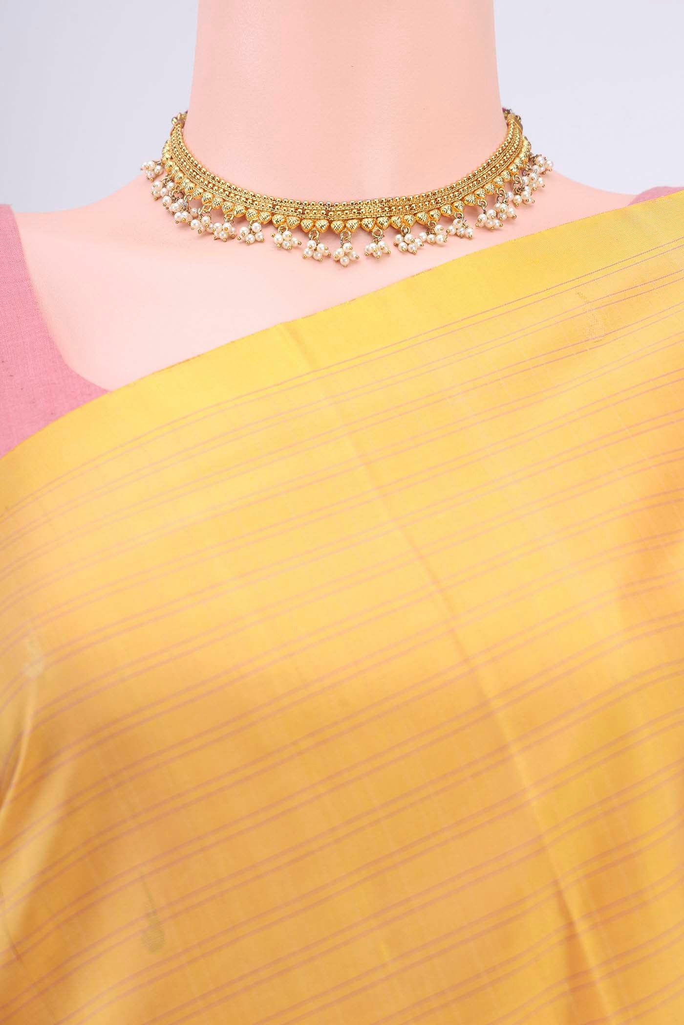 Border image of Yellow Soft Silk Saree with Zari Butta on the body and Zari Border