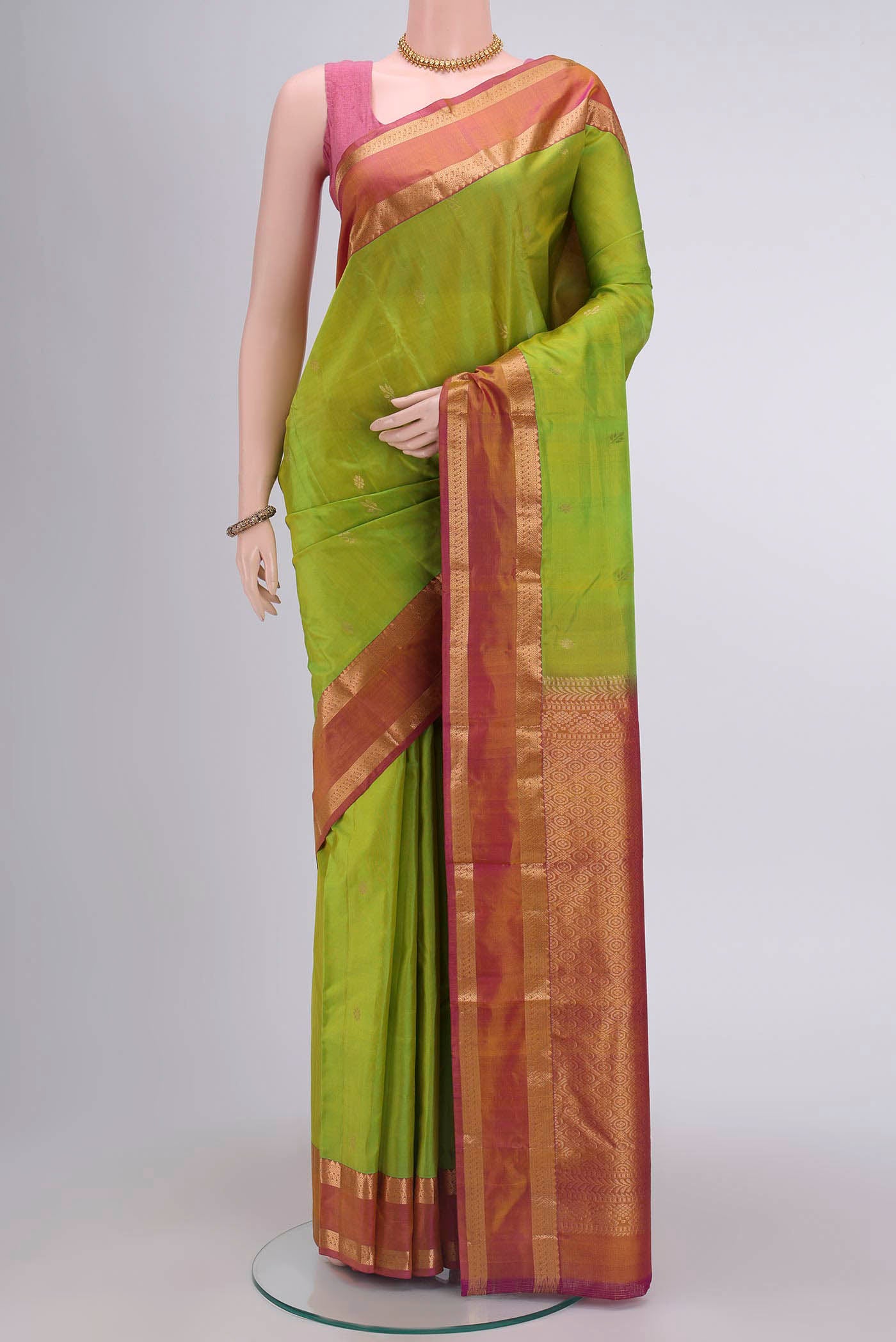 Parrot Green Nangavalli Silk [ Salem ] Saree with Zari Butta on the body and Zari Border displayed on a mannequin