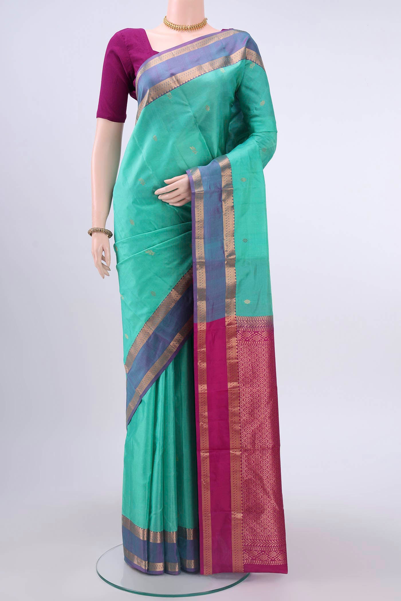 Turquoise Nangavalli Silk [ Salem ] Saree with Zari Butta on the body and Zari Border displayed on a mannequin