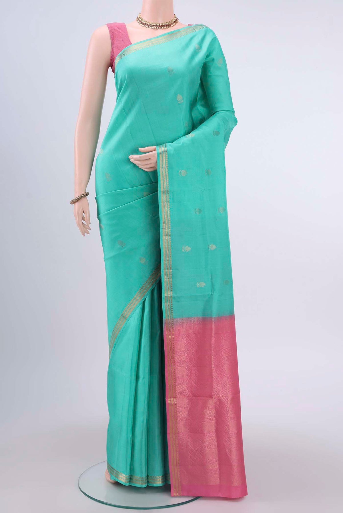 Mint Green Soft Silk Saree with Plain Body and Zari Border displayed on a mannequin