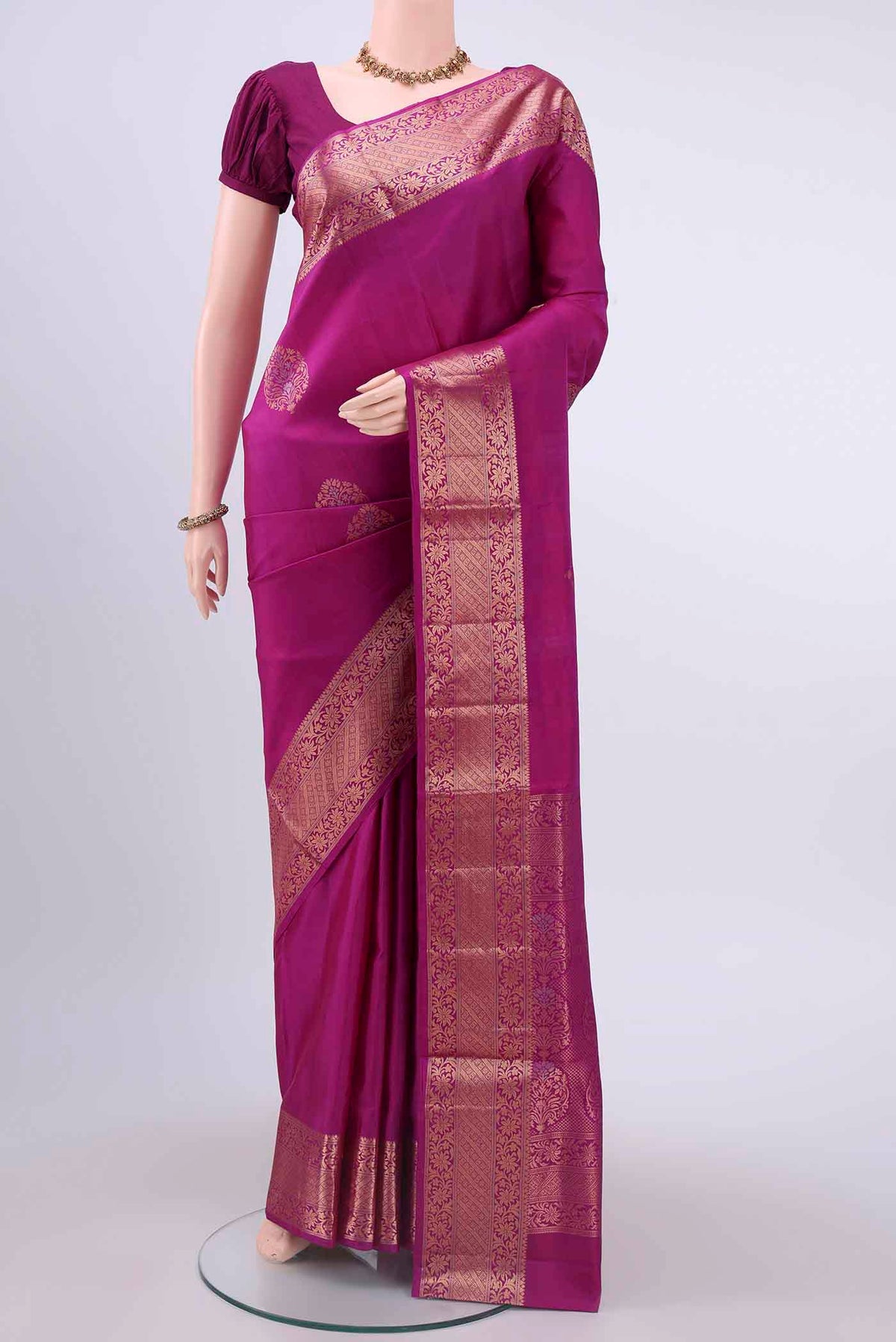 Rani Pink Soft Silk Saree with Zari Butta on the body and Zari Border displayed on a mannequin