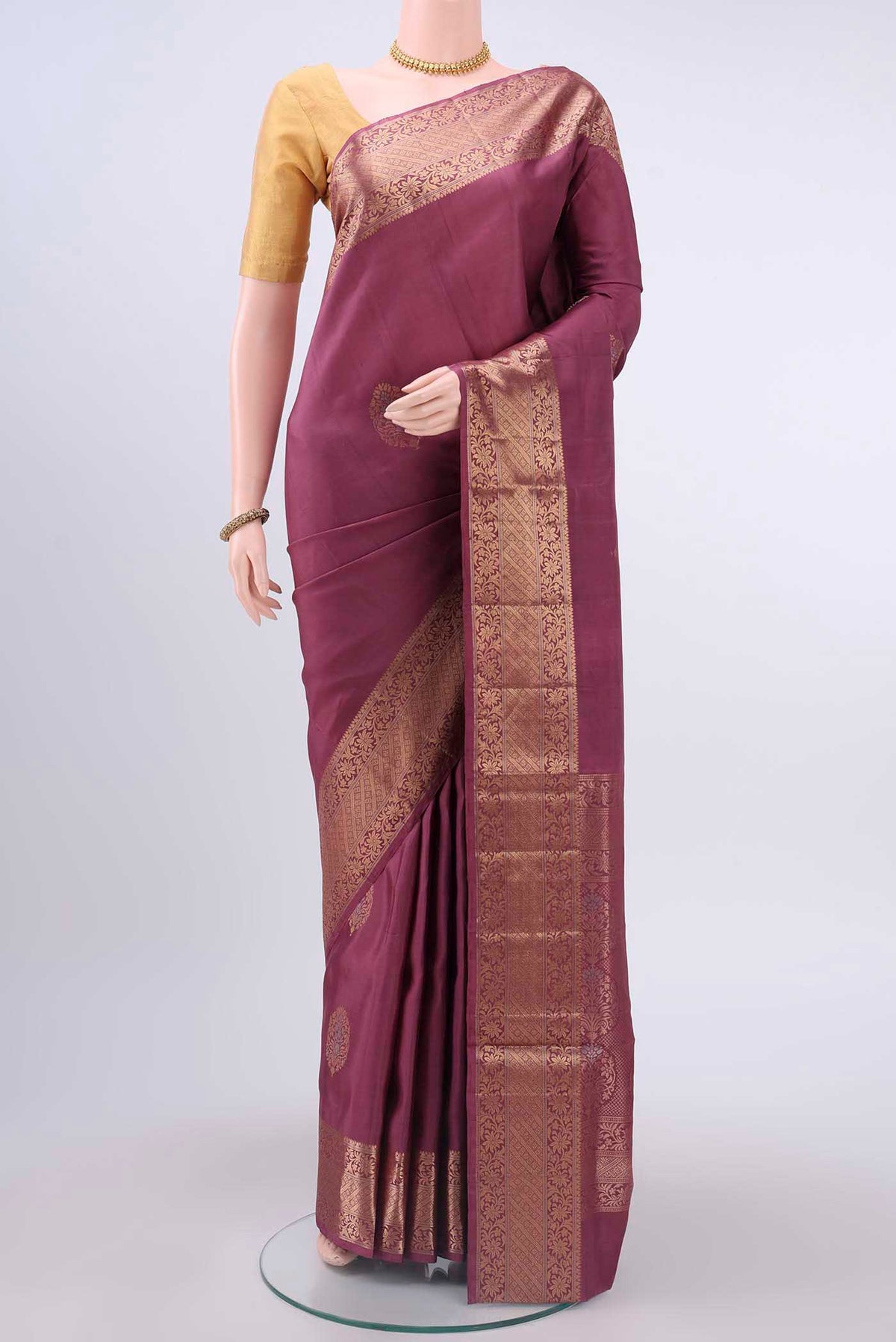 Coral Soft Silk Saree with Zari Butta on the body and Zari Border displayed on a mannequin