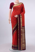 Rust Kanchipuram Silk Saree with Zari Butta on the body and Zari Border displayed on a mannequin